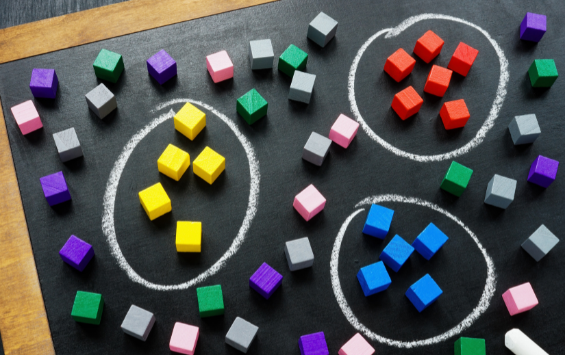 Colored blocks grouped in circles on a chalkboard, illustrating AI for online sales and customer segmentation strategies.